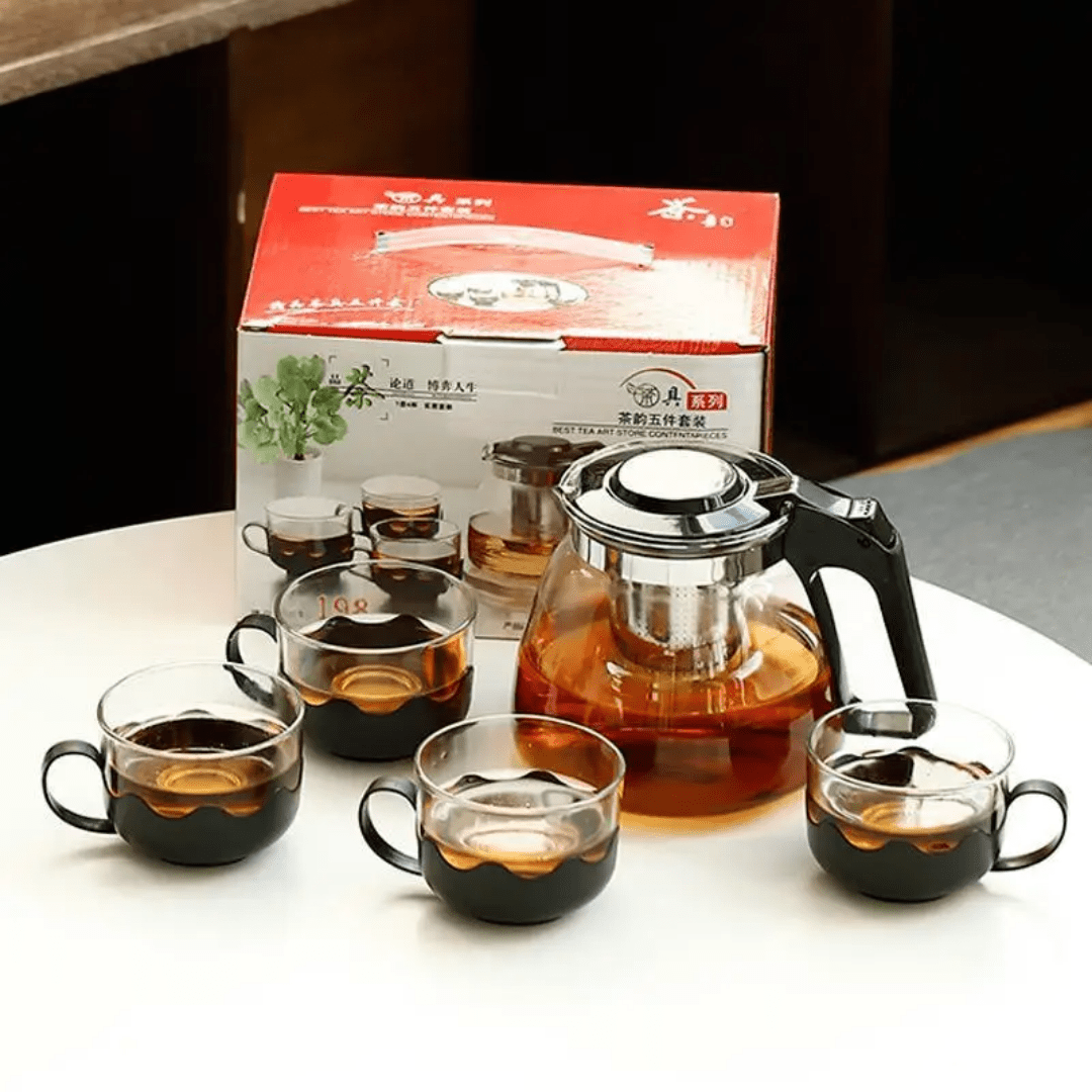 Glass teapot and 4 cups with boiling water and tea inside