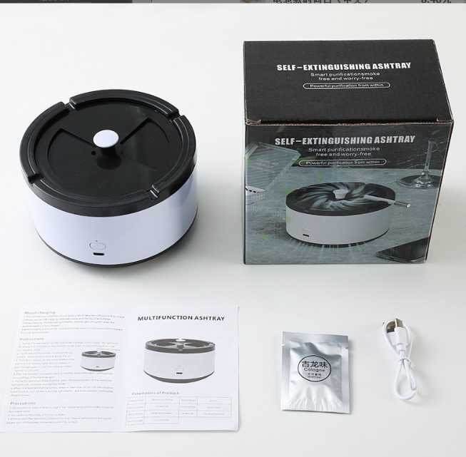 Close-up of white color ashtray with scented disc and accessories